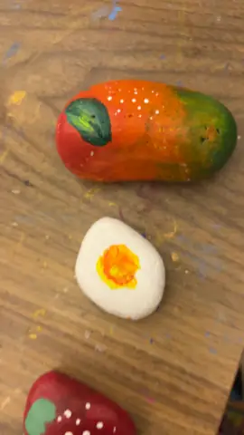 Small painted shapes — fried egg, strawberry and mango