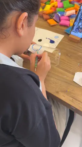 Painting a glass tumbler blue, seen from above