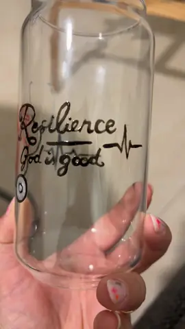 Glass cup painted with a heart and the word Resilience