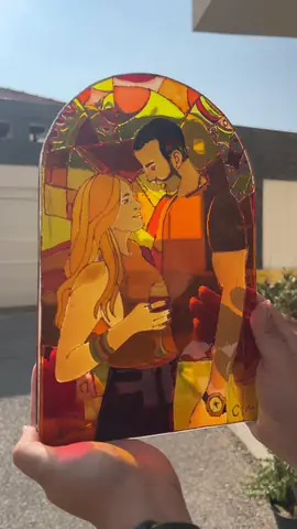 Arch-shaped vitrail glass painting of a couple