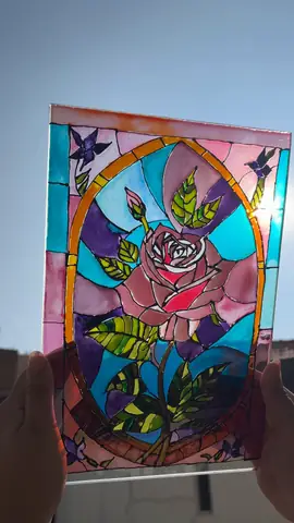 Rose window vitrail painted on glass, held up to the light