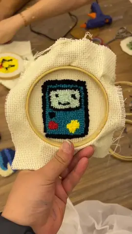 Retro game console punch needle design in a hoop