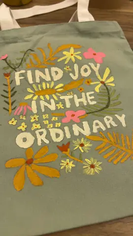 Sage tote bag painted with flowers and the words Find Joy in the Ordinary